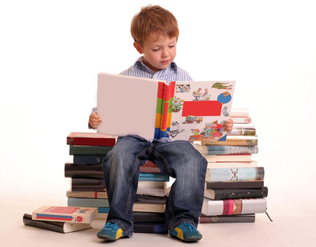 boy_sitting_stack_books_reading_learning_studying